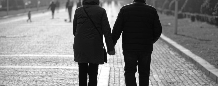 man and woman holding hands walking in winter coats