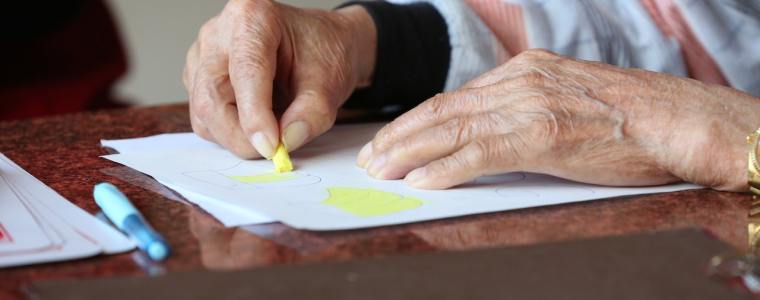 elderly hands drawing during therapy at nursing home